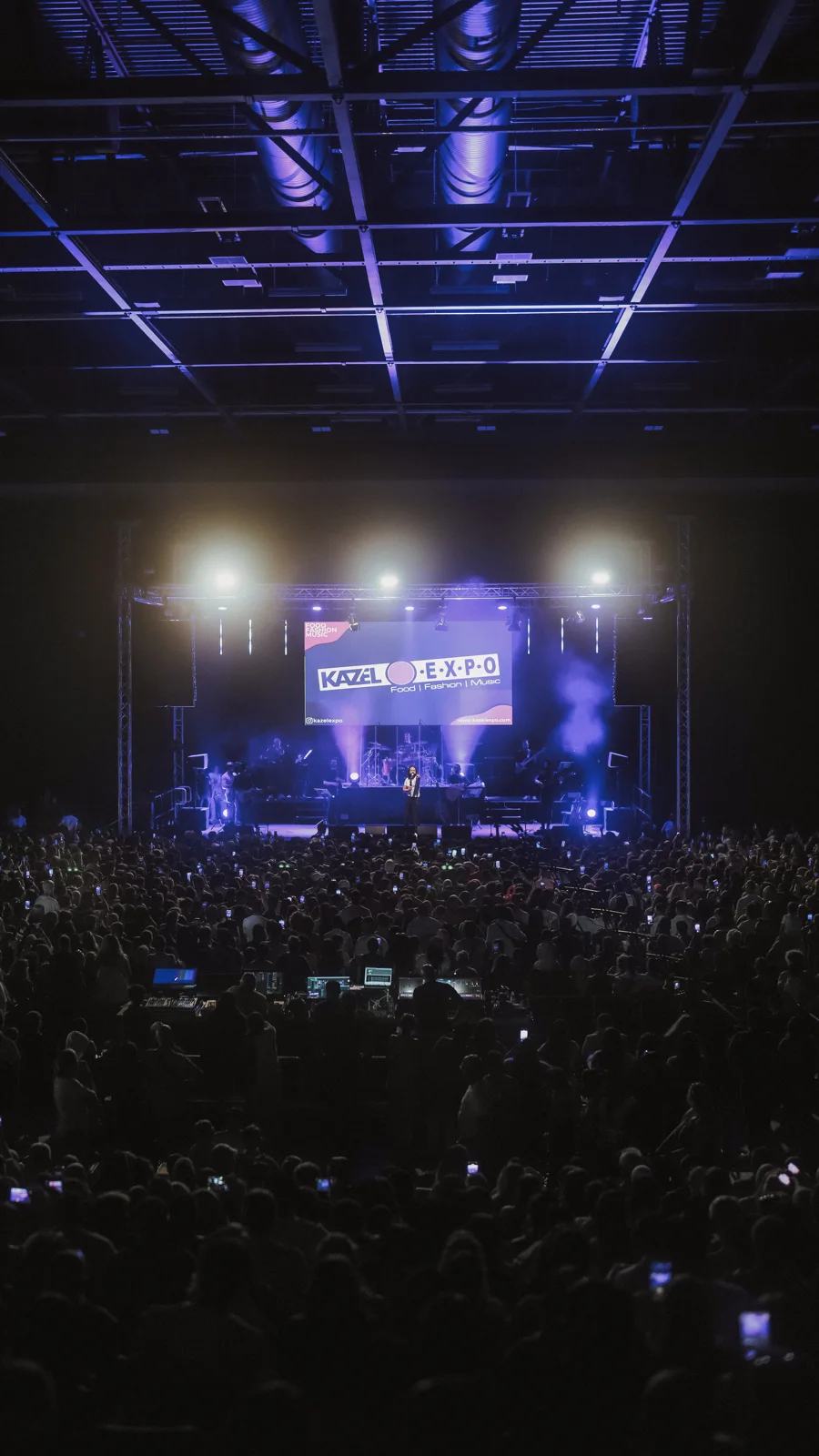 Audience facing a Kazel Expo concert stage